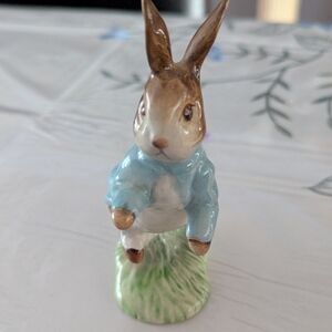 Vintage ceramic figurine of the Peter Rabbit wearing his signature blue Coat